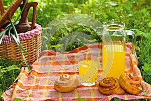 Picnic basket with wine fruit and other products on a natural wooden background. Summer rest . Camping. Picnic in nature