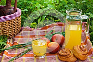 Picnic basket with wine fruit and other products on a natural wooden background. Summer rest . Camping. Picnic in nature