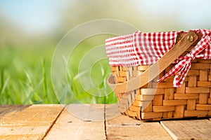 Picnic basket on a wooden table. relaxing on a picnic, and enjoyable in nature, with space