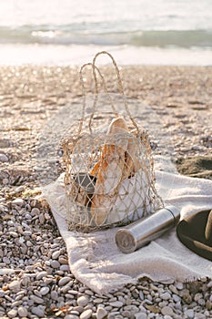 Picnic at beach with baguettes and tea in thermos.