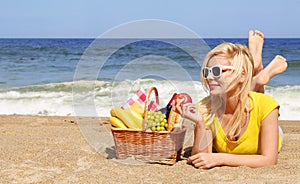 Picnic on the Beach. Blonde Young Woman with Basket