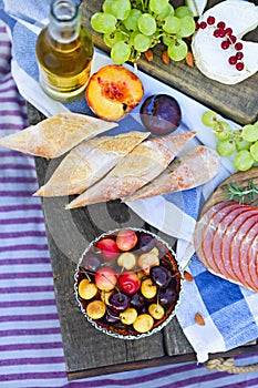 Picnic on the beach at sunset in the style of boho