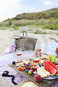 Picnic on the beach at sunset in the style of boho