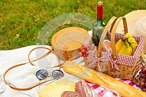 Picnic, camping basket, wine, glasses and fruits, family picnic background with space. Summer and mood. Weekend and vacation,