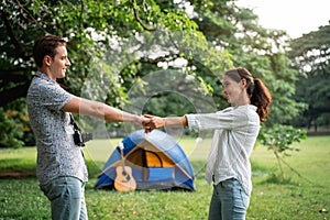 Picnic and Camping time. Young couple having fun in the moment of love in the park. Love and tenderness, Romantic man playing