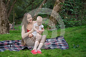 Picnic with children. Togetherness relaxation concept with kid. Mother and child sitting picnic blanket