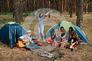 Picnic dinner friends forest guitar music concept.