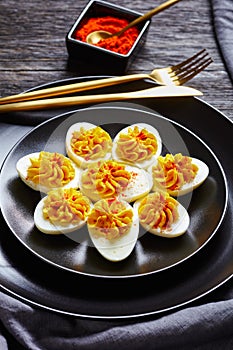 Picnic dish classic deviled eggs on a black plate