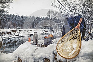 A picnic on a fishing trip, on a snow-covered winter river