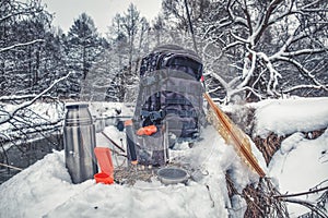 A picnic on a fishing trip, on a snow-covered winter river