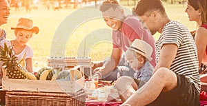 Picnic fun happy family with kids and friends at park. young multi racial families get together in park with cute infant and child