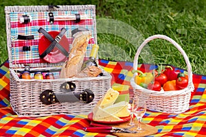 Picnic on the grass. Picnic basket with vegetables and bread. A