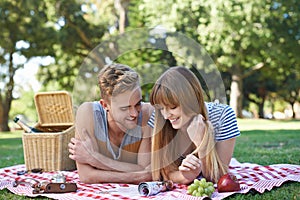 Picnic, love and couple on blanket in park for bonding, relationship and relax on date outdoors. Happy, dating and man