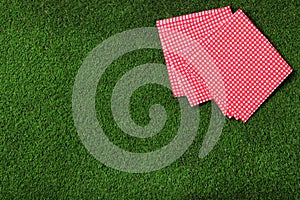 Picnic napkins on grass. Space for text