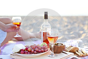 Picnic outdoor with rose wine fruits meat and cheese