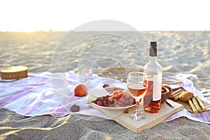 Picnic outdoor with rose wine fruits meat and cheese