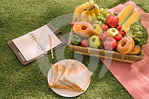Picnic at the park on the grass with food and drink on blanket