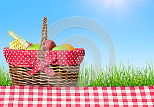 A picnic table covered with checkered tablecloth