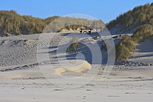 Picnic table in dunes at Ameland Island, Holland photo