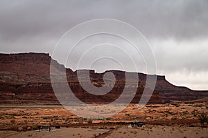 Picnic tables at Hite Marina Campground in Utah, USA during moody cloudy day.