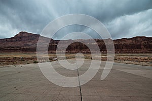 Picnic tables at Hite Marina Campground in Utah, USA during moody cloudy day.