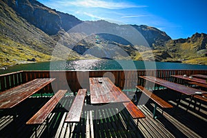 Picnic tables on the shores of the Balea Lake