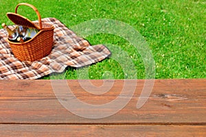 Picnic Tabletop Close-up. Picnic Basket and Blanket On The Lawn