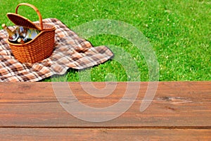 Picnic Tabletop Close-up. Picnic Basket and Blanket On The Lawn photo