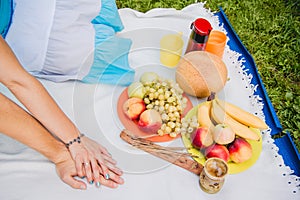 Picnic time. Young couple eating grapes and enjoying in picnic. Love and tenderness, dating, romance, lifestyle concept