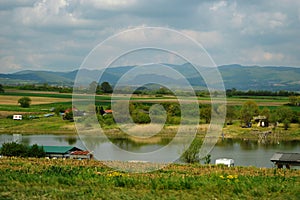 Picnickers and fishermen by the river