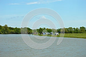 Picnickers on the shore of the lake