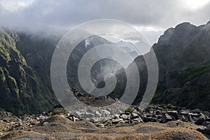 Pico do Arieiro hiking trail, amazing magic landscape with incredible views, rocks and mist, view of the valley between rocks