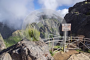 Pico do Arieiro hiking trail, amazing magic landscape with incredible views, rocks and mist, viewpoint with wooden railing