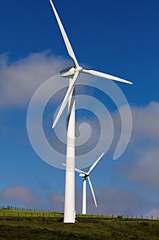 Pico Gallo, Tineo, Asturias, Spain. Two wind turbines with a sky with clouds in the background.