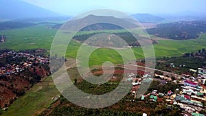 Pictorial aerial view from tropical fields to nearby town