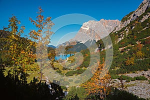 Pictorial autumn landscape, hiking trail to Seebensee mountain lake and view to famous Zugspitze