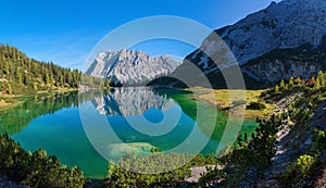 Pictorial colorful autumn landscape, tirolean alps, lake Seebensee and zugspitze mountain