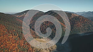 Pictorial hills with green and brown forests lit by sun