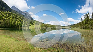 Pictorial lake Lautersee in may, with water reflection. Hiking area Mittenwald, bavaria