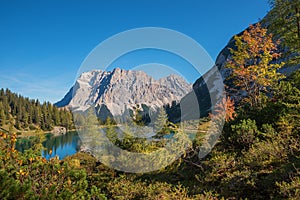 Pictorial lake seebensee in autumnal landscape with view to zugspitze mountain