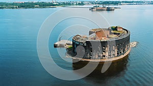 Pictorial old fort surrounded by blue water against city