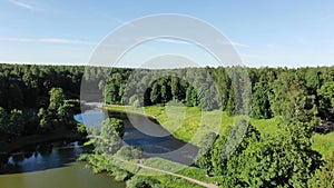 Pictorial park with green trees shadows on deep blue rivers