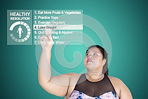 Asian fat woman touches a button of lose weight