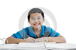 Asian preteen boy writing notes in the studio