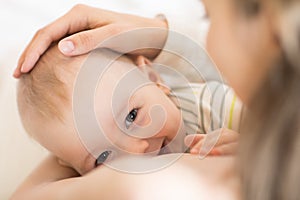 Picture of baby feeds mom`s breast