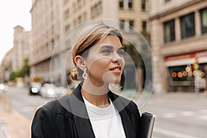 Picture of beautiful caucasian woman looking away and walking in the city