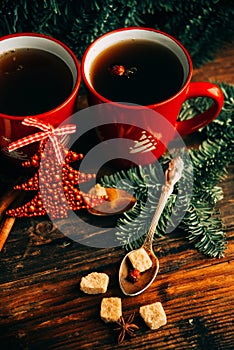 Picture of beautiful Christmas table setting, shining white plate with red cup for coffee decorated holiday dinner, branch of berr