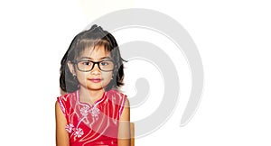 Picture of beautiful liitle girl in red chinese dress wearing eye glasses sitting on chair