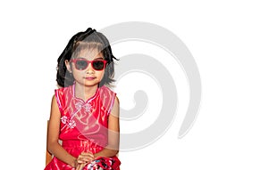 Picture of beautiful liitle girl in red chinese dress wearing sun glasses sitting on chair