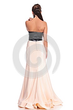 Picture from behind of a young woman in beautiful gown